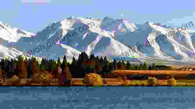 A Panoramic View Of New Zealand's Rugged Coastline With Snow Capped Mountains In The Distance New Zealand The Outsiders Inside Guide