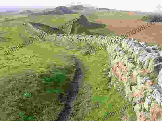 A Section Of Hadrian's Wall, With Its Distinctive Stonework And Rolling Green Hills In The Background Hadrian S Cycleway Coast 2 Coast